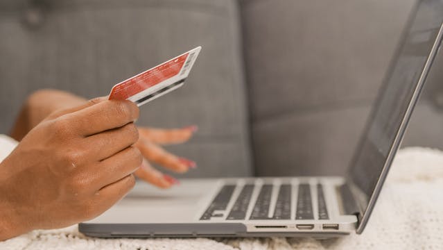 Person making an online payment using a computer